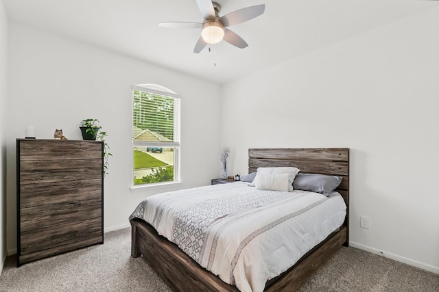 carpeted bedroom with baseboards and a ceiling fan