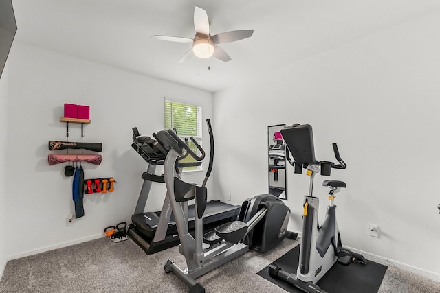 workout room with baseboards and ceiling fan