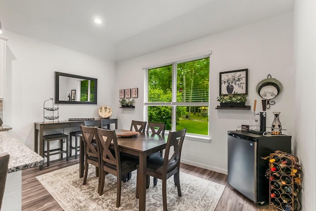 dining area featuring plenty of natural light, recessed lighting, baseboards, and wood finished floors
