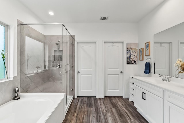 bathroom with visible vents, vanity, a garden tub, and a shower stall