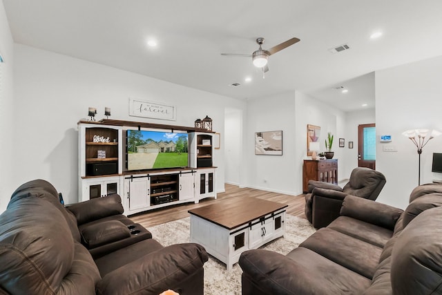 living area with ceiling fan, recessed lighting, baseboards, wood finished floors, and visible vents