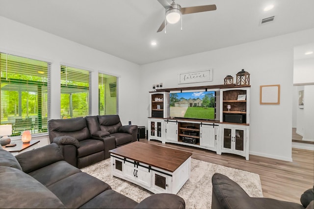 living area featuring visible vents, wood finished floors, baseboards, recessed lighting, and a ceiling fan