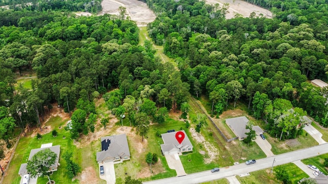 drone / aerial view featuring a view of trees