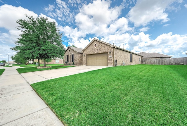 single story home featuring a front lawn, fence, brick siding, concrete driveway, and an attached garage