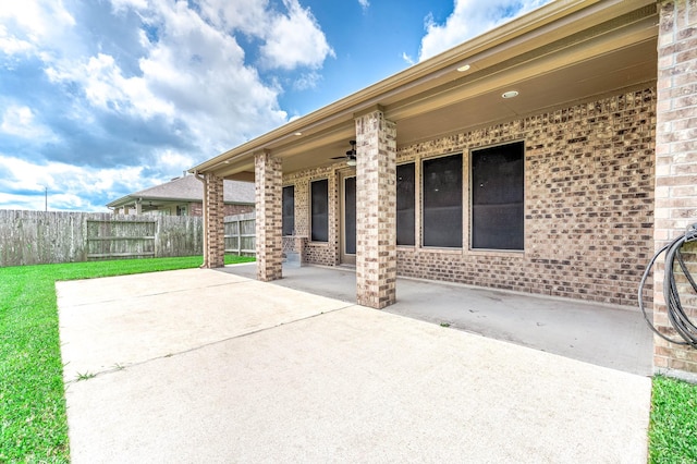 view of patio with ceiling fan and fence