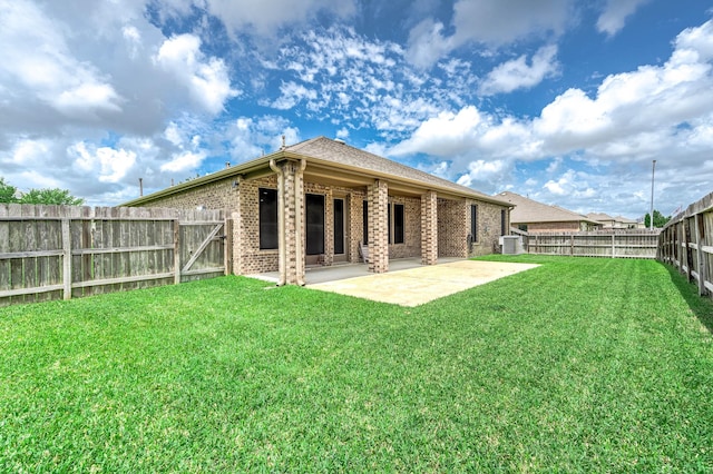 back of house with cooling unit, a patio, a fenced backyard, brick siding, and a lawn