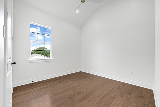 spare room with baseboards, ceiling fan, dark wood finished floors, and lofted ceiling