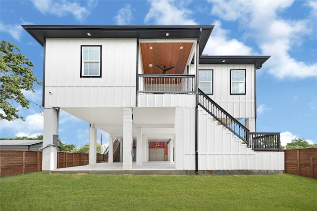 203 Dwire Dr, La Porte, TX 77571 - rear view of property with board and batten siding, stairway, a patio area, a lawn, and fence private yard