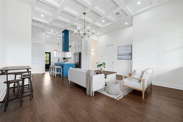 living room with a high ceiling, a notable chandelier, dark wood finished floors, and beam ceiling
