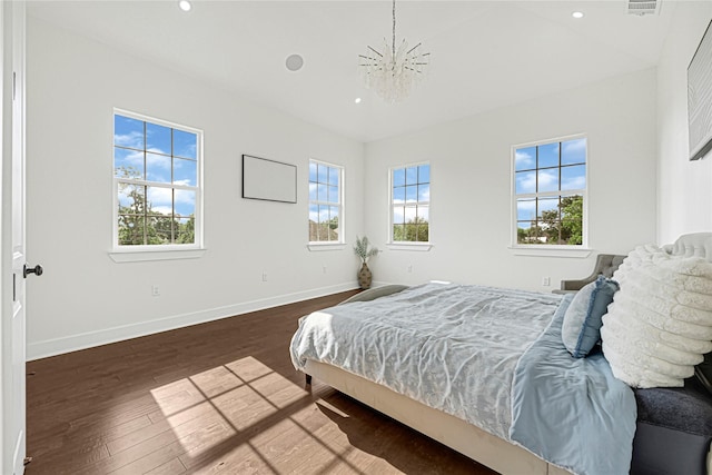 bedroom featuring an inviting chandelier, recessed lighting, baseboards, and wood finished floors