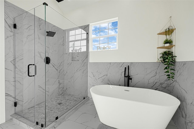 full bath featuring tile walls, a marble finish shower, and marble finish floor