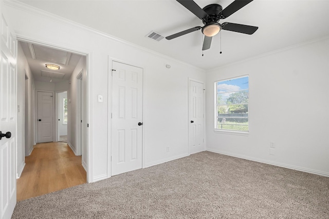 7817 Woodlyn Rd, Houston, TX 77028 - unfurnished bedroom with attic access, light carpet, ornamental molding, baseboards, and a ceiling fan