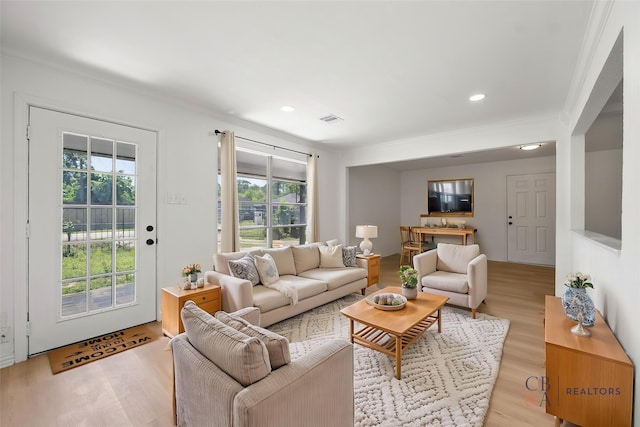 7817 Woodlyn Rd, Houston, TX 77028 - living room with crown molding, plenty of natural light, light wood finished floors, and recessed lighting