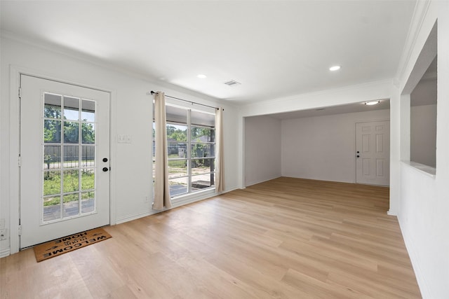 7817 Woodlyn Rd, Houston, TX 77028 - doorway to outside featuring ornamental molding, healthy amount of natural light, light wood finished floors, recessed lighting, and baseboards