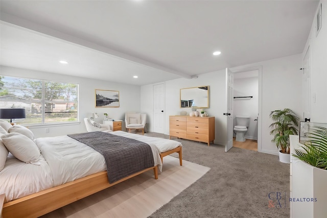 7817 Woodlyn Rd, Houston, TX 77028 - bedroom with recessed lighting, ensuite bathroom, light carpet, and beam ceiling