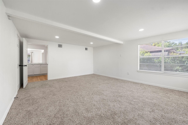 7817 Woodlyn Rd, Houston, TX 77028 - spare room featuring light carpet, recessed lighting, baseboards, and beam ceiling