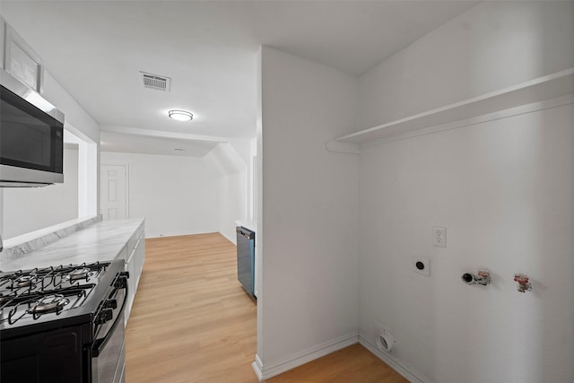 7817 Woodlyn Rd, Houston, TX 77028 - washroom featuring light wood-type flooring and gas dryer hookup