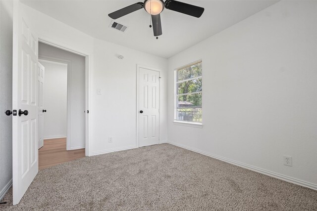 7817 Woodlyn Rd, Houston, TX 77028 - unfurnished bedroom featuring carpet, baseboards, ceiling fan, and a closet