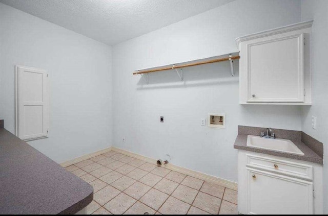 washroom featuring washer hookup, electric dryer hookup, a textured ceiling, a sink, and baseboards