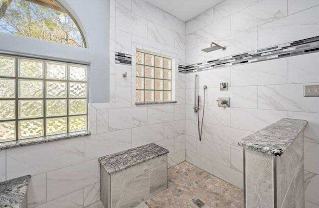 full bath with tiled shower