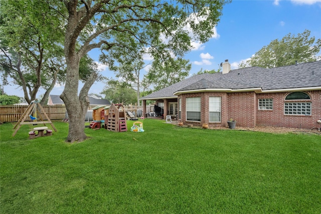 view of yard featuring a fenced backyard and a playground