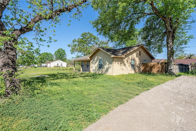 ranch-style house with fence and a front yard