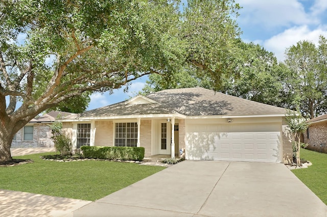 ranch-style house featuring an attached garage, roof with shingles, driveway, and a front yard