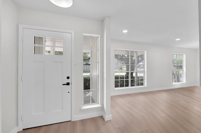 entryway with recessed lighting, baseboards, and light wood finished floors
