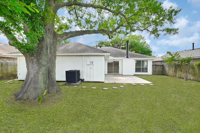back of property featuring fence, a patio, a shingled roof, a lawn, and central air condition unit