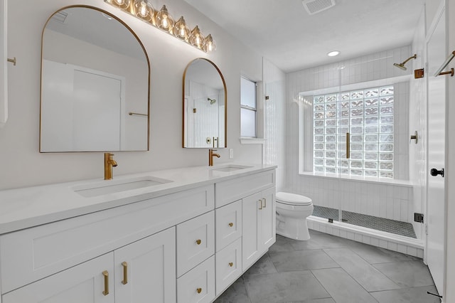 full bathroom with visible vents, a sink, and a stall shower