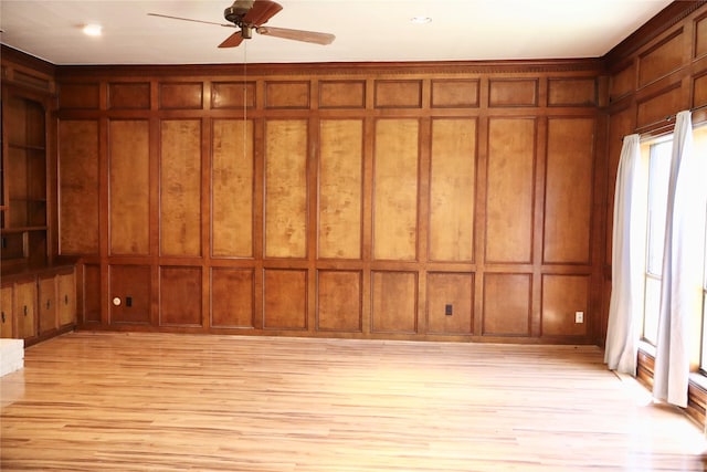 12835 Ashford Chase Dr, Houston, TX 77082 - unfurnished room with a ceiling fan, light wood-type flooring, and a decorative wall