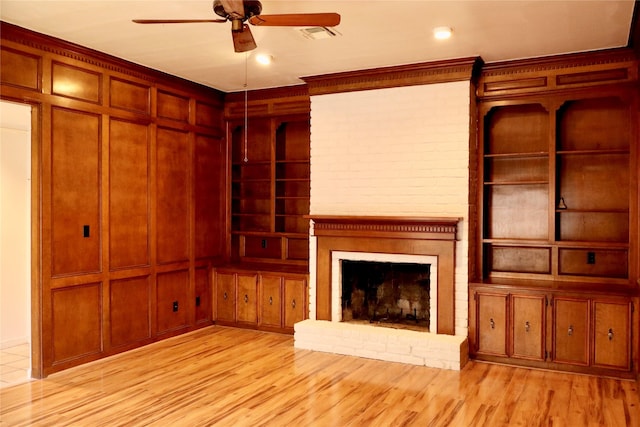 12835 Ashford Chase Dr, Houston, TX 77082 - unfurnished living room with light wood-style floors, built in features, ceiling fan, and a fireplace