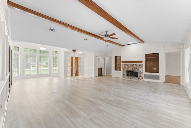 unfurnished living room featuring ceiling fan, a fireplace, built in features, vaulted ceiling with beams, and visible vents