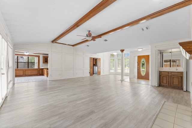 unfurnished living room with a decorative wall, a ceiling fan, vaulted ceiling with beams, light wood-type flooring, and visible vents