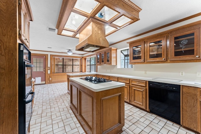kitchen with visible vents, brown cabinetry, brick patterned floor, light countertops, and black appliances