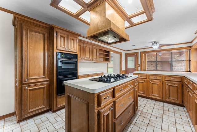 kitchen featuring light countertops, dobule oven black, brown cabinetry, gas stovetop, and a kitchen island
