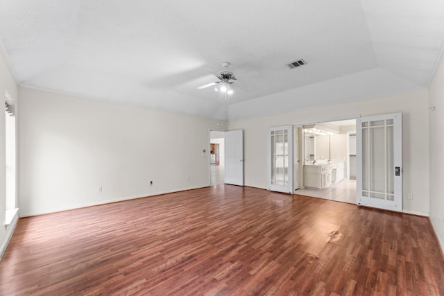 unfurnished living room with crown molding, ceiling fan, baseboards, wood finished floors, and visible vents