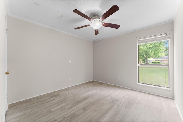 spare room with crown molding, a ceiling fan, baseboards, and light wood-style floors