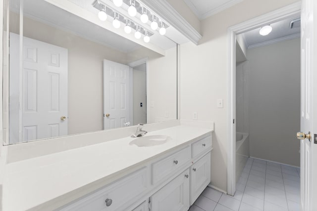 bathroom with visible vents, tile patterned flooring, vanity, ornamental molding, and a tub to relax in
