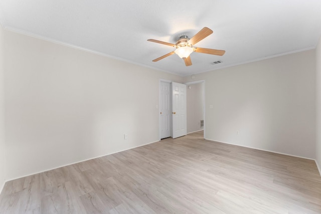 empty room featuring visible vents, a ceiling fan, light wood-style flooring, and crown molding