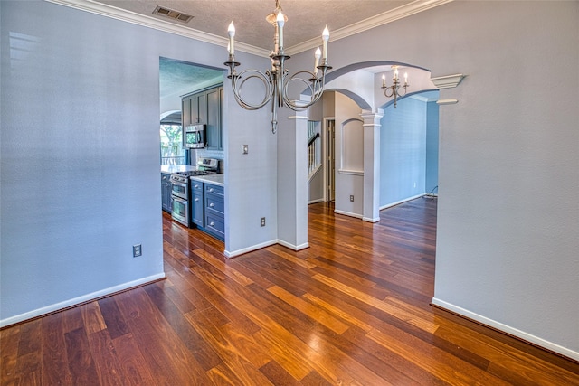 unfurnished dining area featuring arched walkways, a chandelier, ornamental molding, wood finished floors, and baseboards
