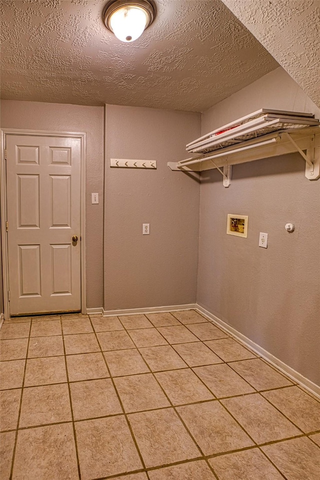 laundry room featuring hookup for a washing machine, light tile patterned floors, a textured ceiling, and baseboards