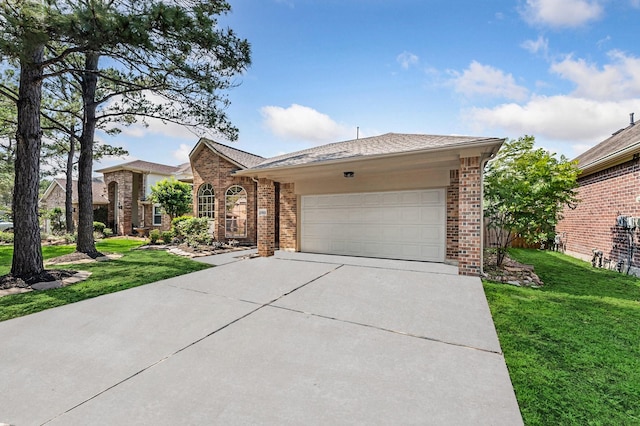 ranch-style home featuring brick siding, a garage, a front lawn, and driveway