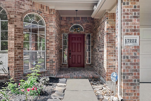 doorway to property with brick siding