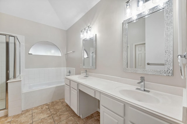 full bathroom featuring double vanity, a shower stall, a sink, and a bath