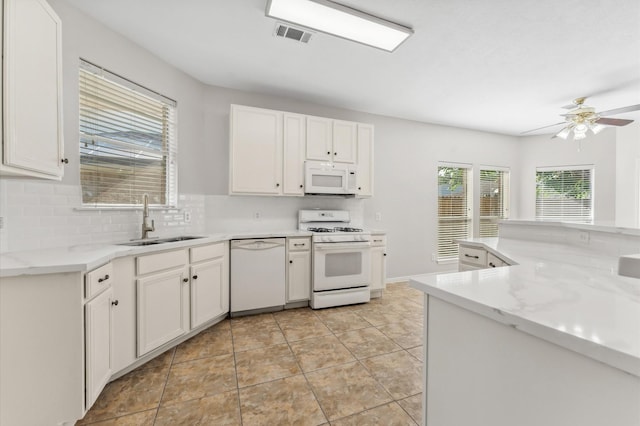 kitchen featuring a sink, a ceiling fan, white cabinets, and white appliances