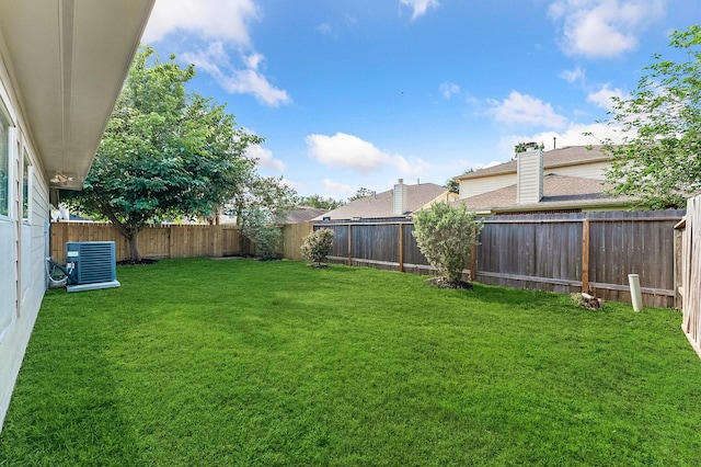 view of yard with a fenced backyard and cooling unit