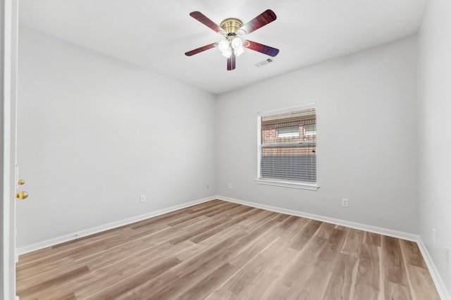 spare room with a ceiling fan, baseboards, visible vents, and light wood-style floors