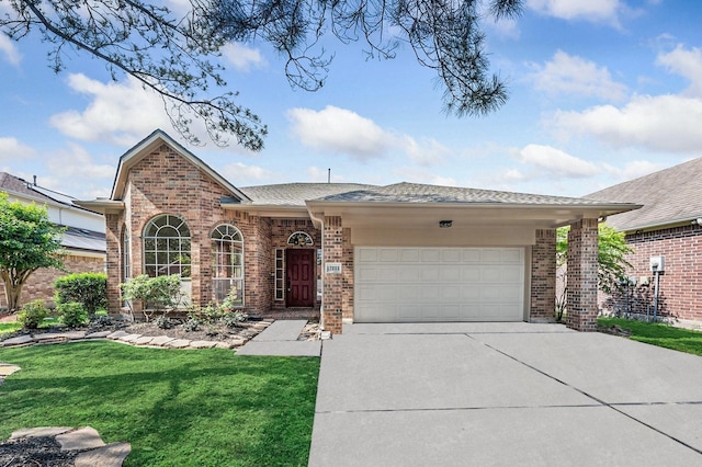view of front of house with a garage, concrete driveway, a front lawn, and brick siding