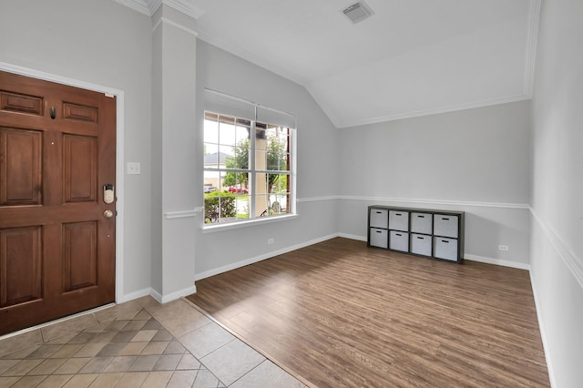entryway featuring visible vents, baseboards, tile patterned floors, and vaulted ceiling